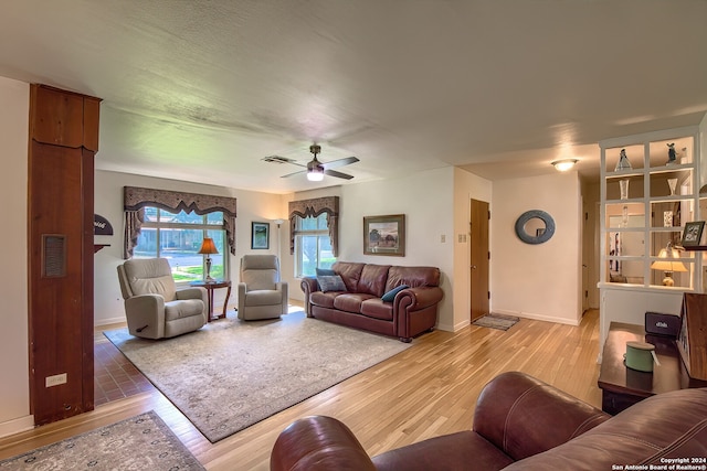 living room featuring light hardwood / wood-style floors and ceiling fan