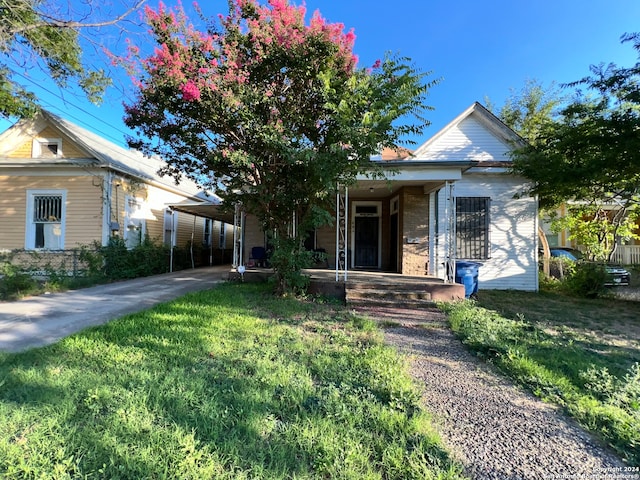 view of front facade featuring a carport and a front lawn