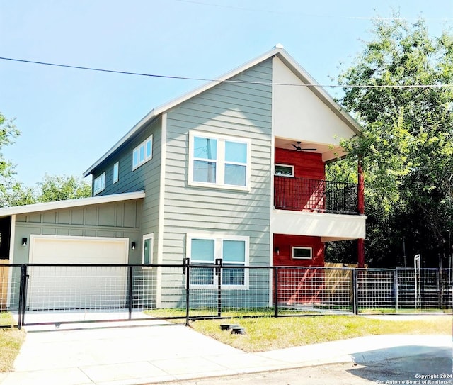 view of front facade featuring a garage, ceiling fan, and a balcony