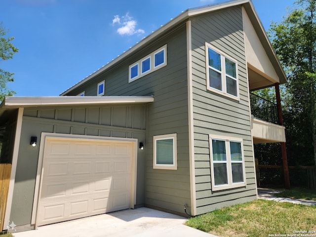 view of front of home featuring a garage and a balcony