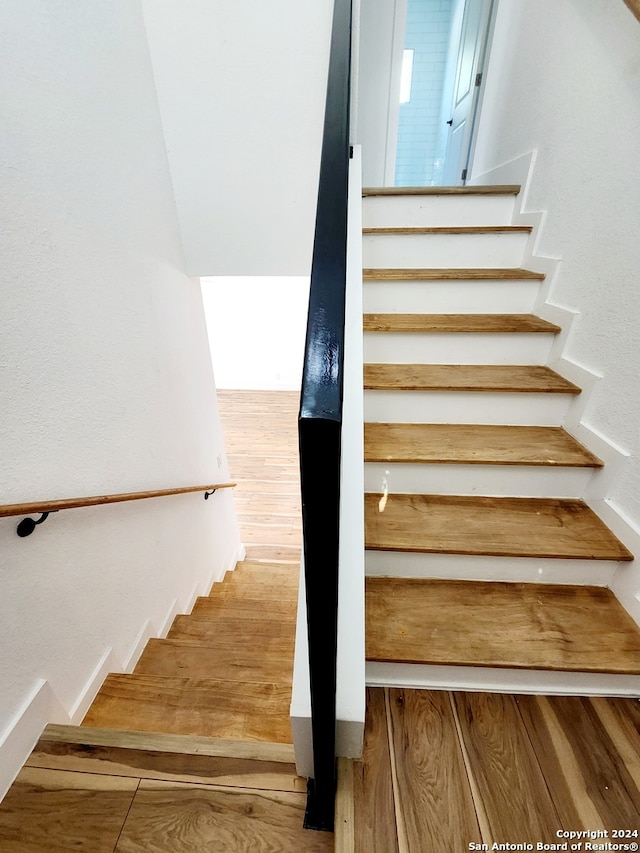 stairway with wood-type flooring