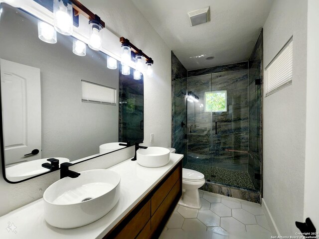 full bathroom featuring tiled shower / bath combo, vanity, tile patterned flooring, and toilet