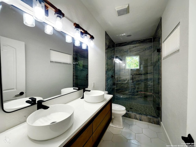 bathroom with vanity, toilet, a shower with shower door, and tile patterned floors