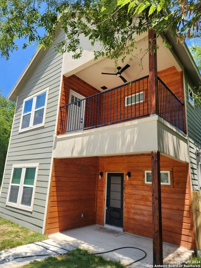 exterior space featuring a balcony and ceiling fan