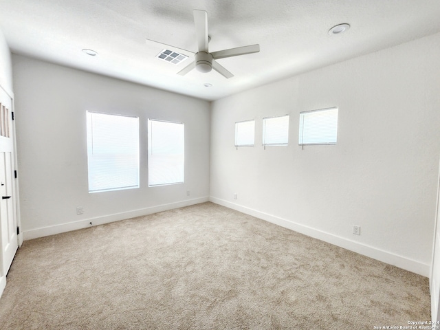 unfurnished room with ceiling fan and light colored carpet