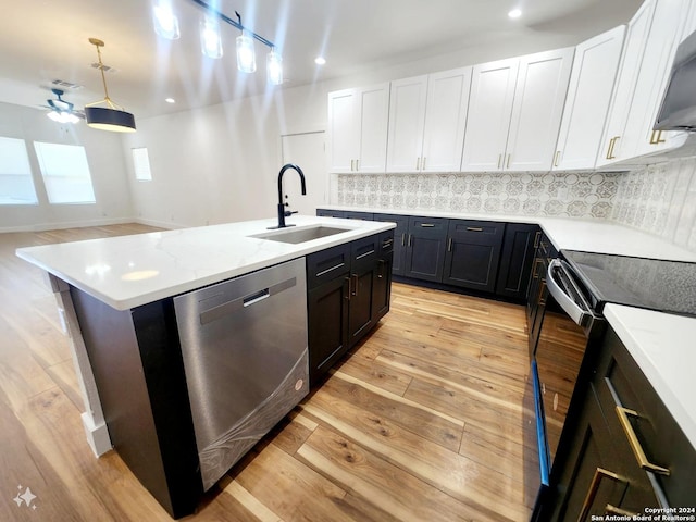 kitchen with sink, white cabinetry, black electric range, stainless steel dishwasher, and a kitchen island with sink