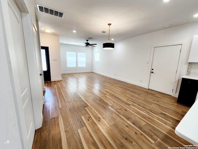 interior space with ceiling fan and light hardwood / wood-style flooring