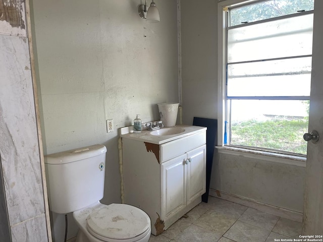 bathroom featuring tile patterned floors, toilet, and vanity