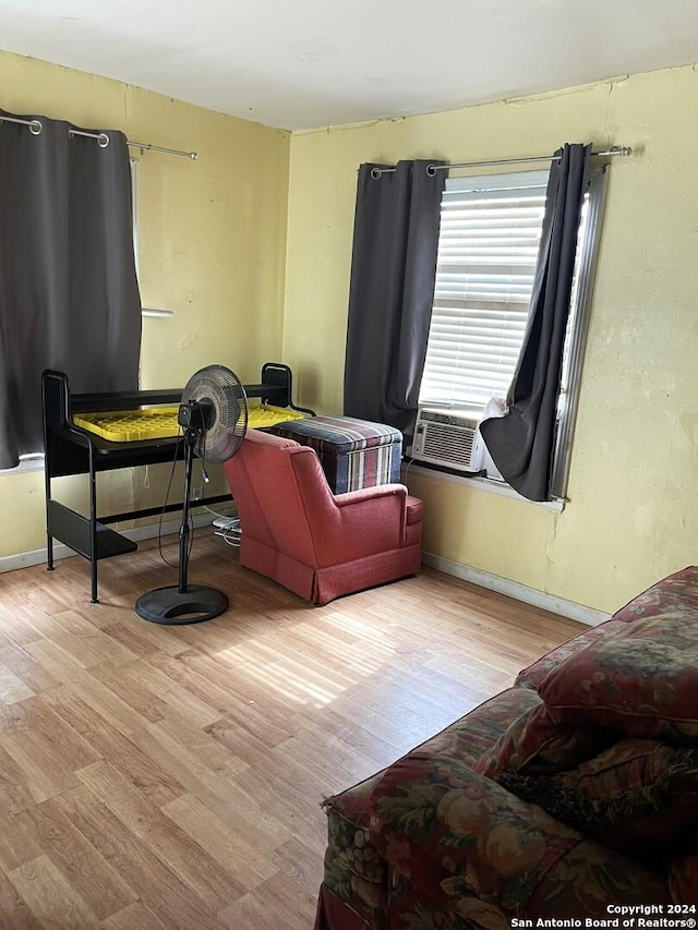 interior space featuring baseboards, cooling unit, and wood finished floors