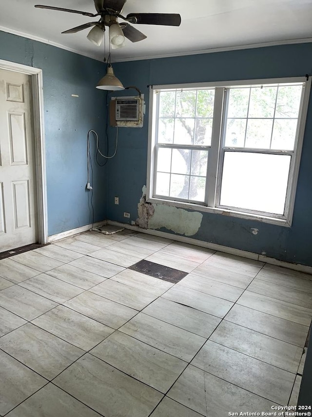 empty room featuring baseboards, a wall unit AC, ornamental molding, and a ceiling fan