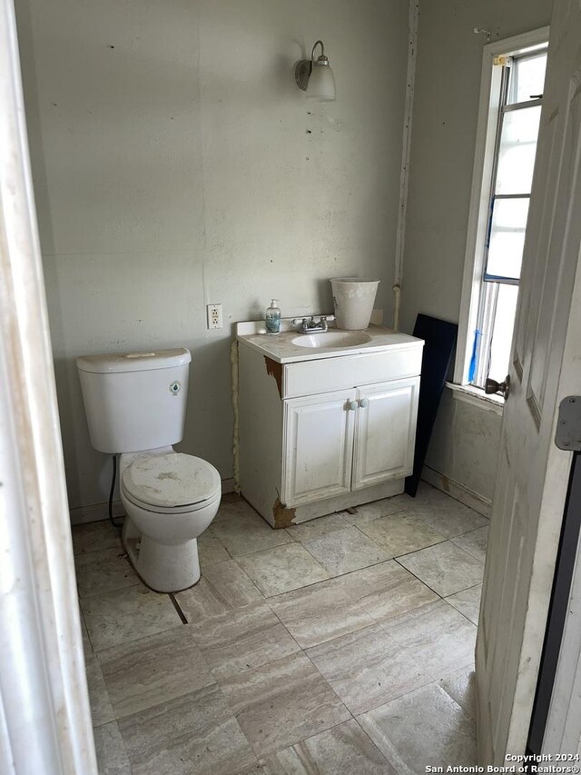 half bath featuring toilet and vanity