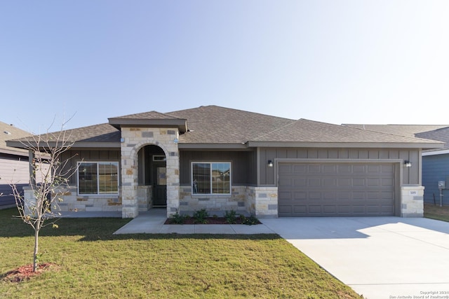 prairie-style house featuring driveway, board and batten siding, an attached garage, and a front yard