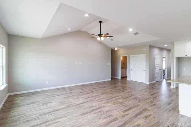 unfurnished living room featuring light wood-style flooring, recessed lighting, a ceiling fan, baseboards, and vaulted ceiling