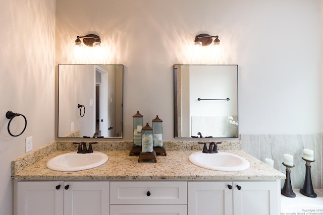 bathroom with a sink and double vanity