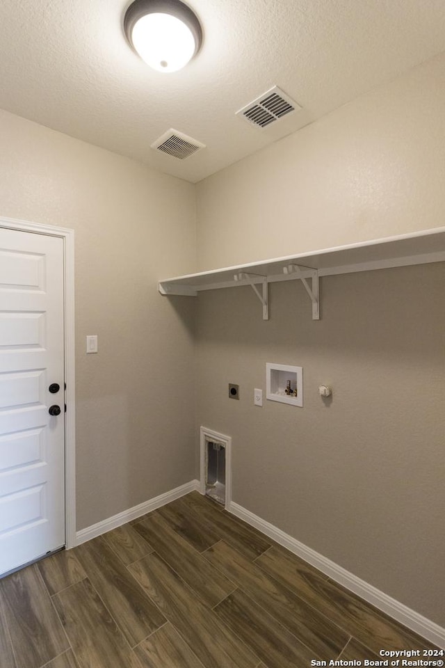 clothes washing area with laundry area, washer hookup, dark wood finished floors, and visible vents