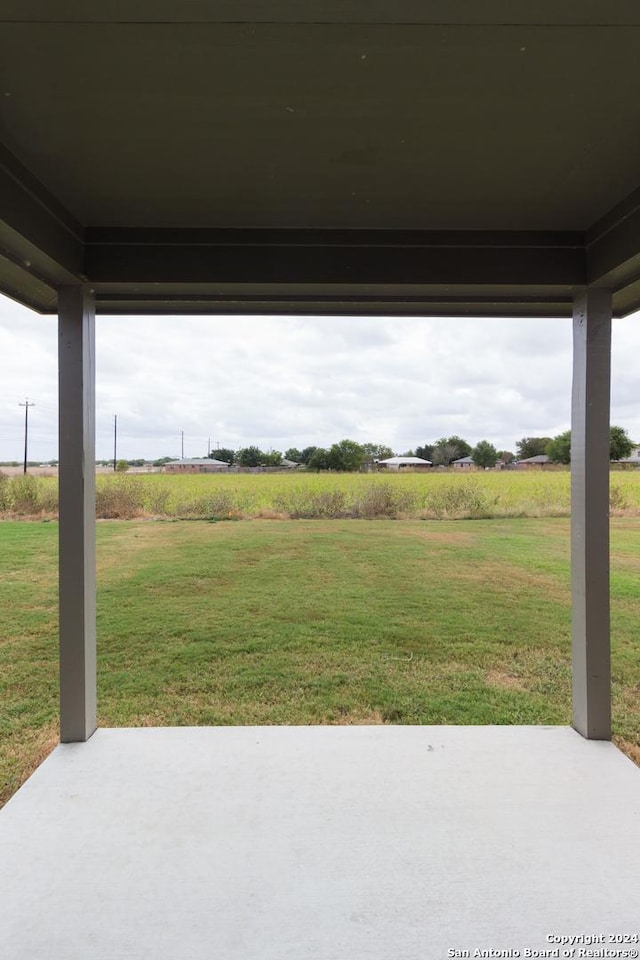 view of yard featuring a rural view and a patio