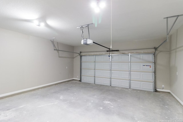 garage with a garage door opener and baseboards