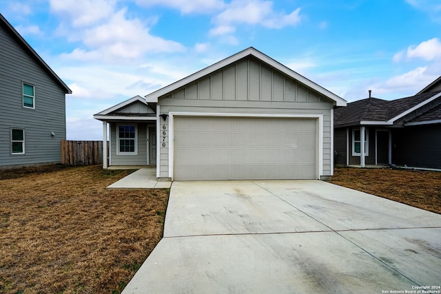 ranch-style house with a garage and a front lawn