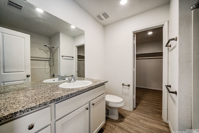 bathroom with vanity, hardwood / wood-style flooring, and toilet