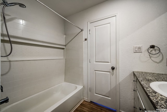 bathroom featuring vanity, tiled shower / bath, and hardwood / wood-style floors