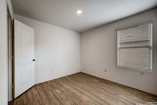 empty room with hardwood / wood-style floors