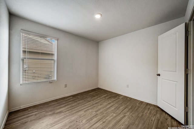 spare room with hardwood / wood-style flooring