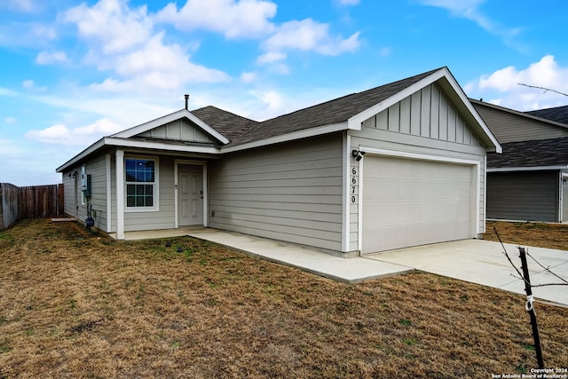 ranch-style home featuring a garage and a front lawn