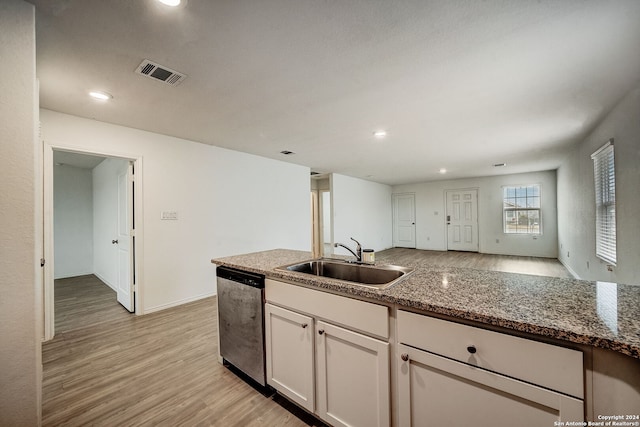 kitchen featuring light hardwood / wood-style floors, sink, stainless steel dishwasher, and white cabinetry