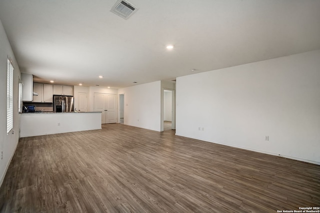 unfurnished living room with wood-type flooring