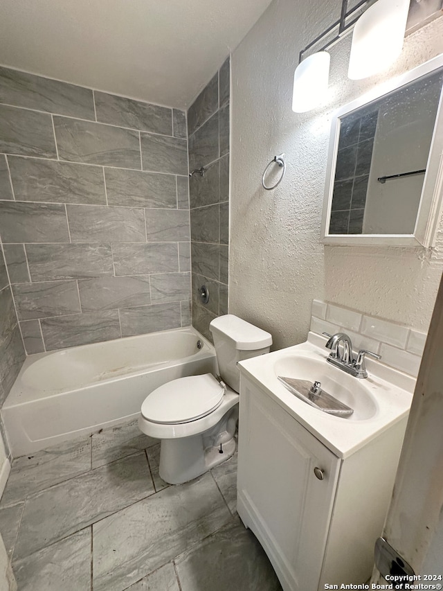 full bathroom featuring vanity, tiled shower / bath, tile patterned flooring, and toilet