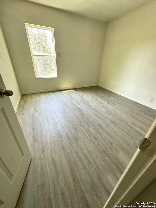 spare room with light hardwood / wood-style floors