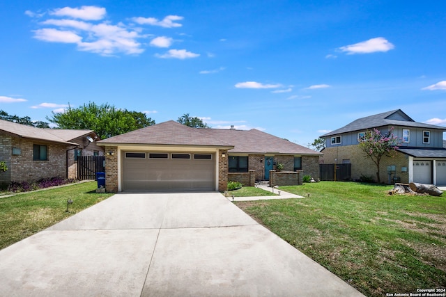 view of front of house featuring a garage and a front lawn