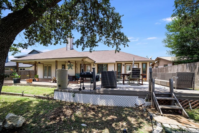 rear view of property featuring a wooden deck