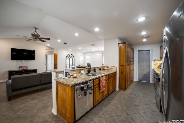 kitchen featuring ceiling fan, sink, light stone counters, appliances with stainless steel finishes, and light tile patterned floors