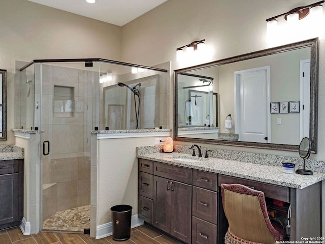 bathroom featuring vanity and an enclosed shower