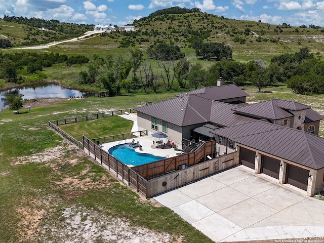 birds eye view of property with a water view and a rural view