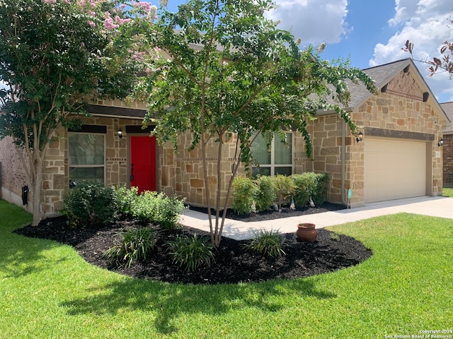 view of front of house featuring a garage and a front lawn