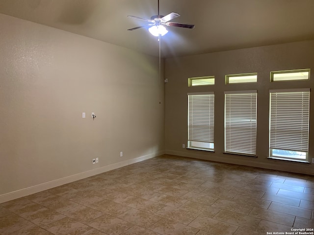 tiled empty room with ceiling fan