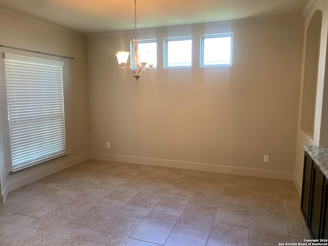 unfurnished dining area featuring a chandelier, crown molding, and light tile patterned floors