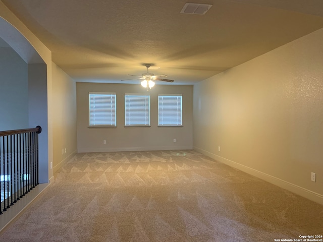 carpeted empty room with ceiling fan