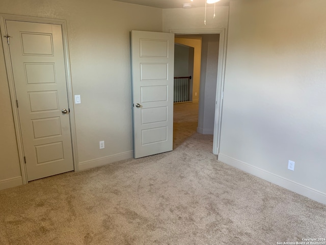 empty room featuring light carpet