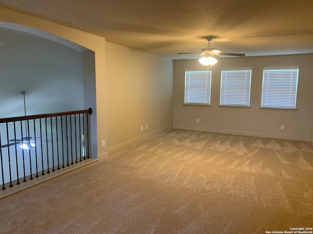 carpeted empty room with ceiling fan