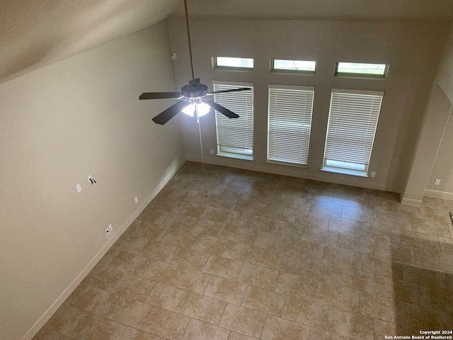 unfurnished living room with tile patterned floors, ceiling fan, and high vaulted ceiling