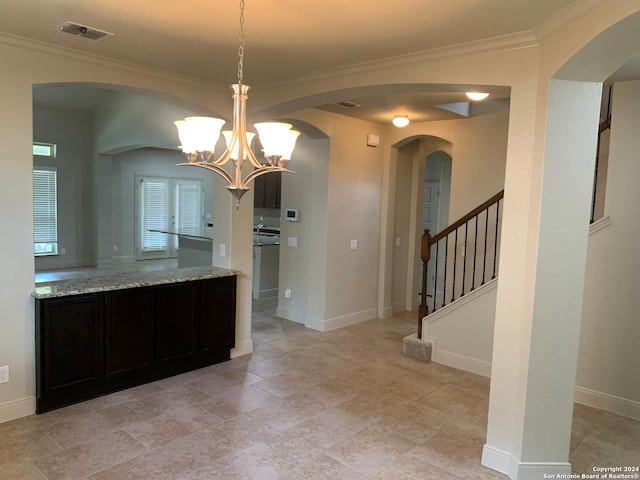 bathroom featuring tile patterned flooring, a notable chandelier, and crown molding