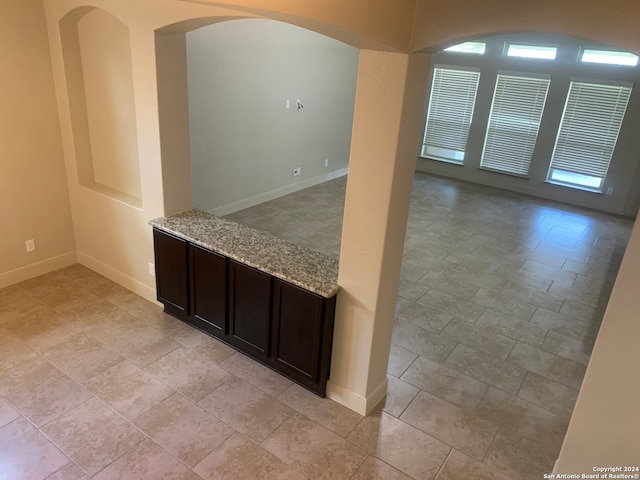 interior space with light tile patterned flooring and a wealth of natural light