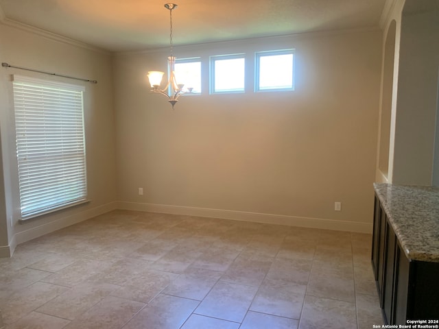 unfurnished dining area featuring crown molding, a chandelier, and light tile patterned floors