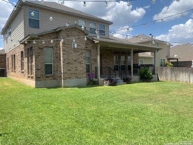 back of house with a lawn