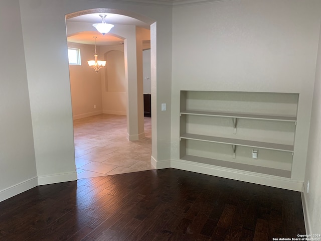 interior space with a notable chandelier and hardwood / wood-style floors