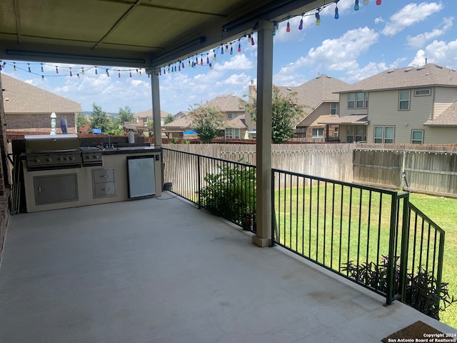 view of patio / terrace featuring exterior kitchen and a grill