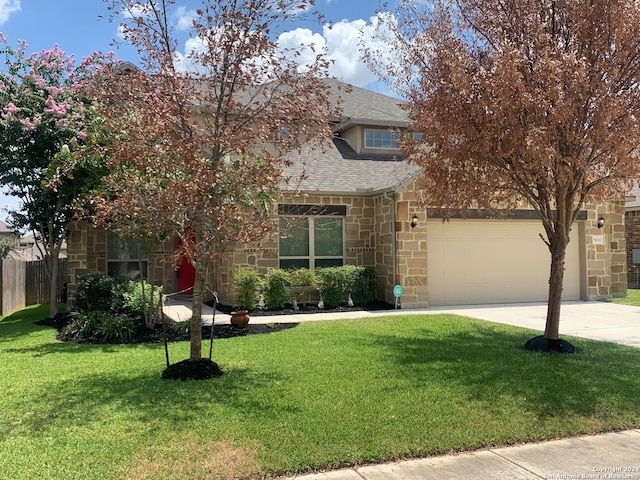 obstructed view of property featuring a garage and a front yard